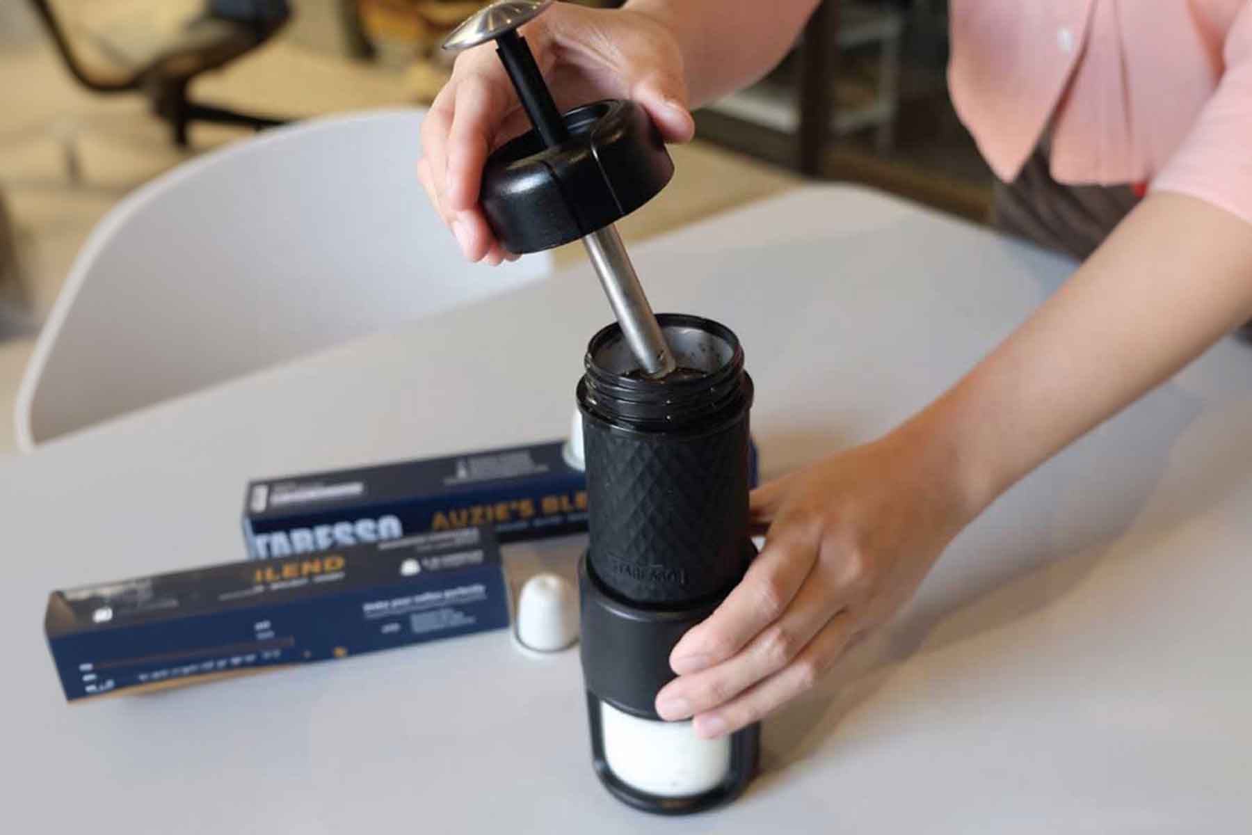 Demonstrating how to open the espresso maker and make delicious on the go coffee.